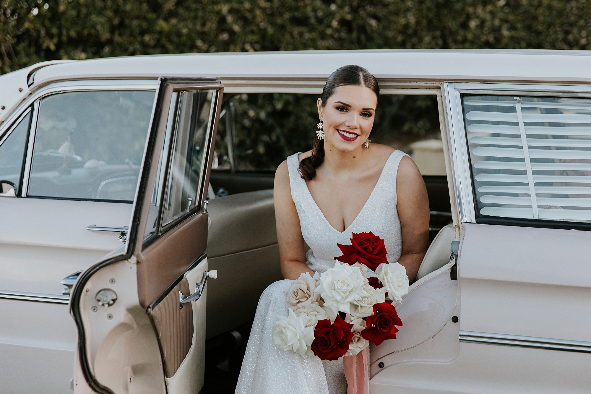 Bride sitting in Pastel Pink 1963 XL Ford Falcon Deluxe Wagon
